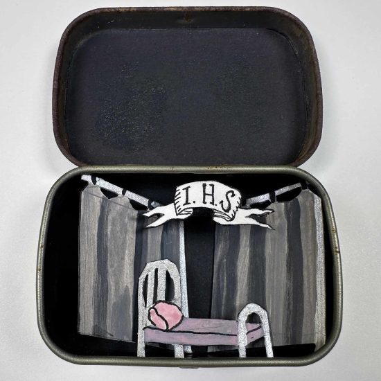 A mournful lonely bed in a dark hospital setting - cut paper diorama in Altoids smalls tin.